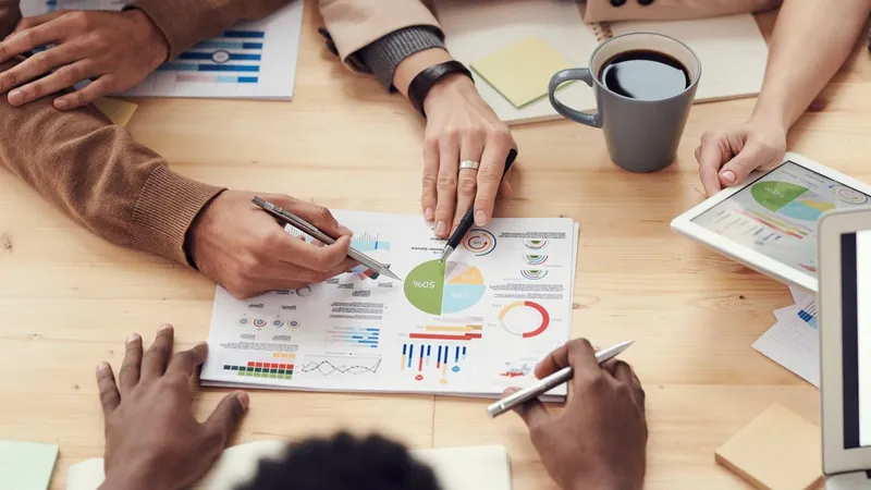 Consultants reviewing printed search performance charts during an SEO audit